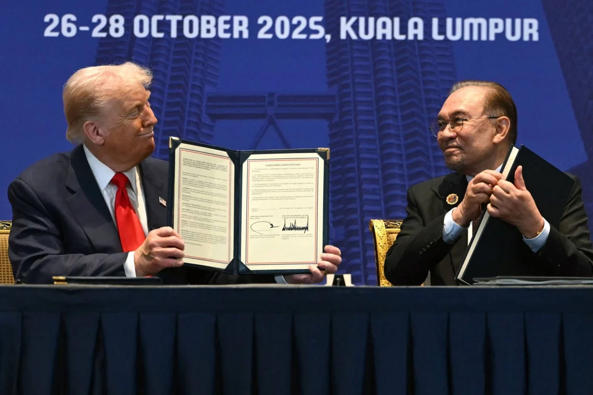 US President Donald Trump and Malaysia’s Prime Minister Anwar Ibrahim hold signed documents during a bilateral meeting on the sidelines of the Asean summit in Kuala Lumpur on Sunday
